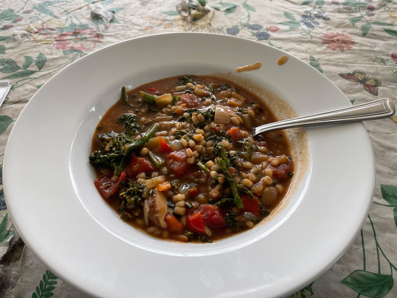 bowl of soup with barley, vegetables, and shiitake mushrooms.